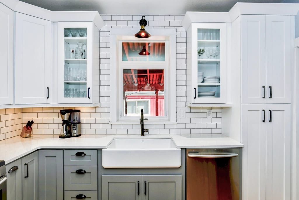 White kitchen with a farmhouse sink and subway tile